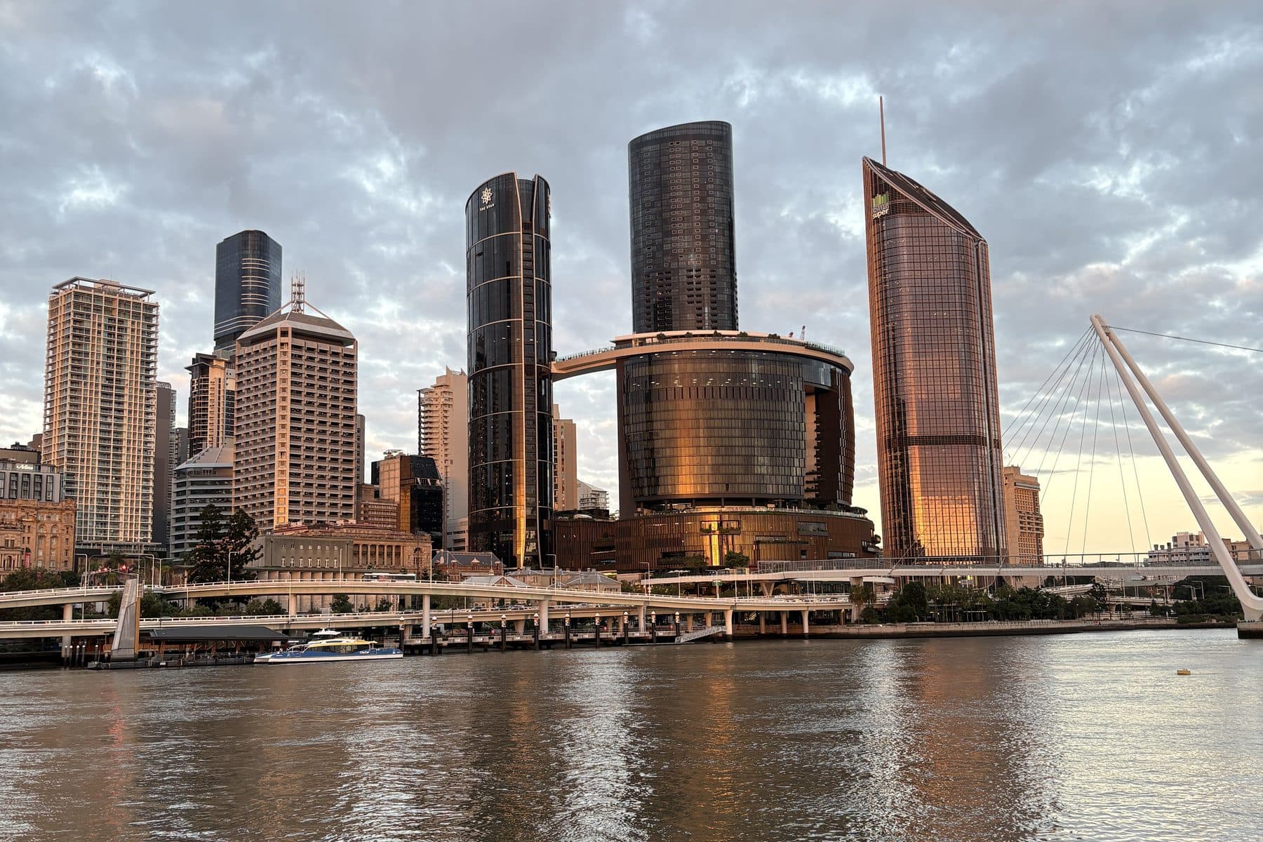 The Brisbane city skyline seen across the Brisbane River at dusk