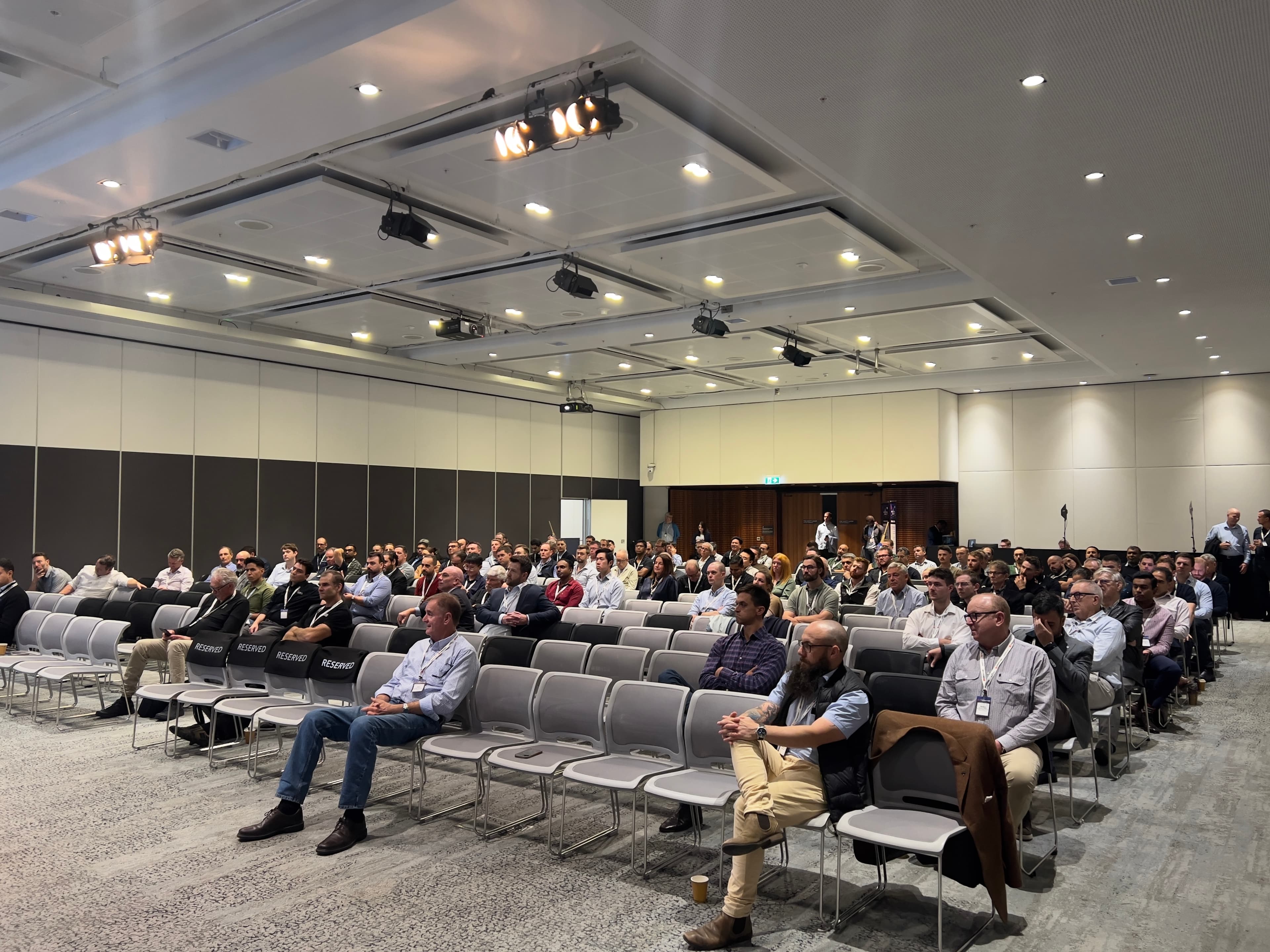 A conference crowd during Tam's presentation